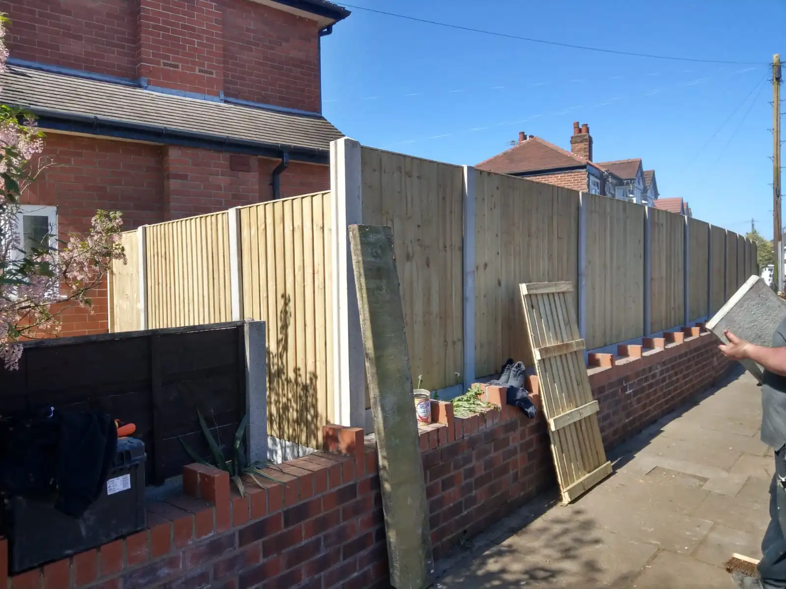 Close-lap panel fencing installation in progress showing professional workmanship